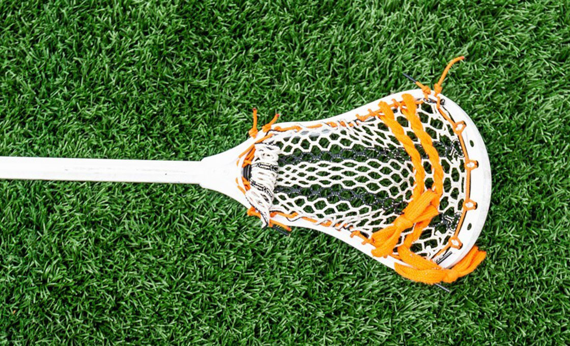 Close-up of lacrosse turf fibers showing sand and rubber infill
