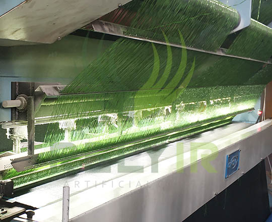 Tufting artificial grass fibers into backing cloth