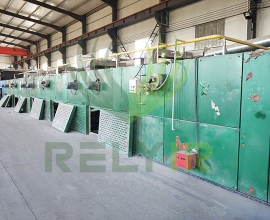 Drying coated artificial grass in oven