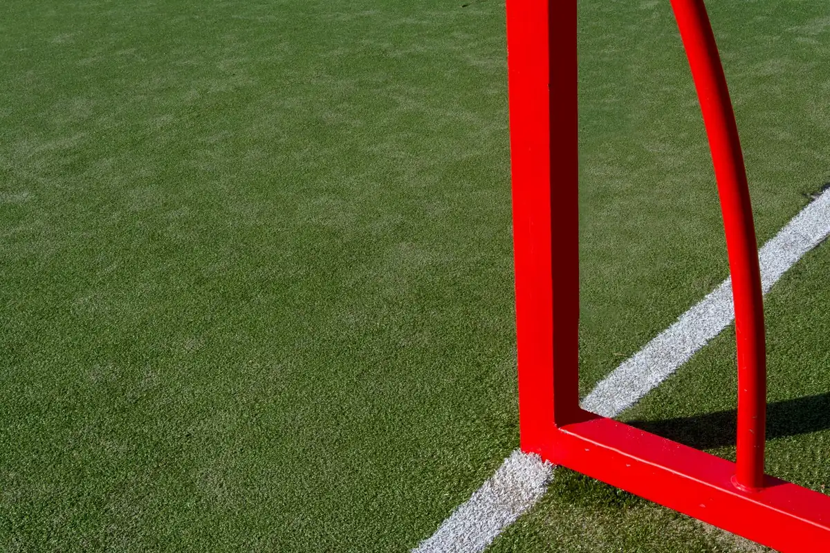 Soccer field corner with a goalpost on artificial turf