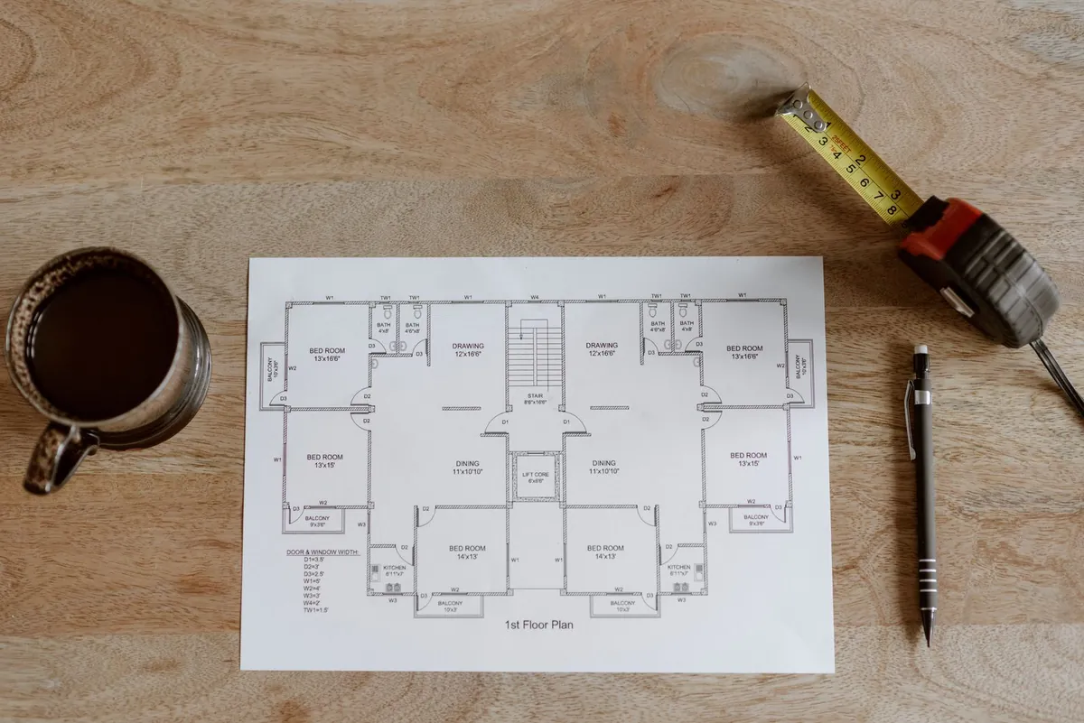 Pitch plans with tape measure and pencil from above