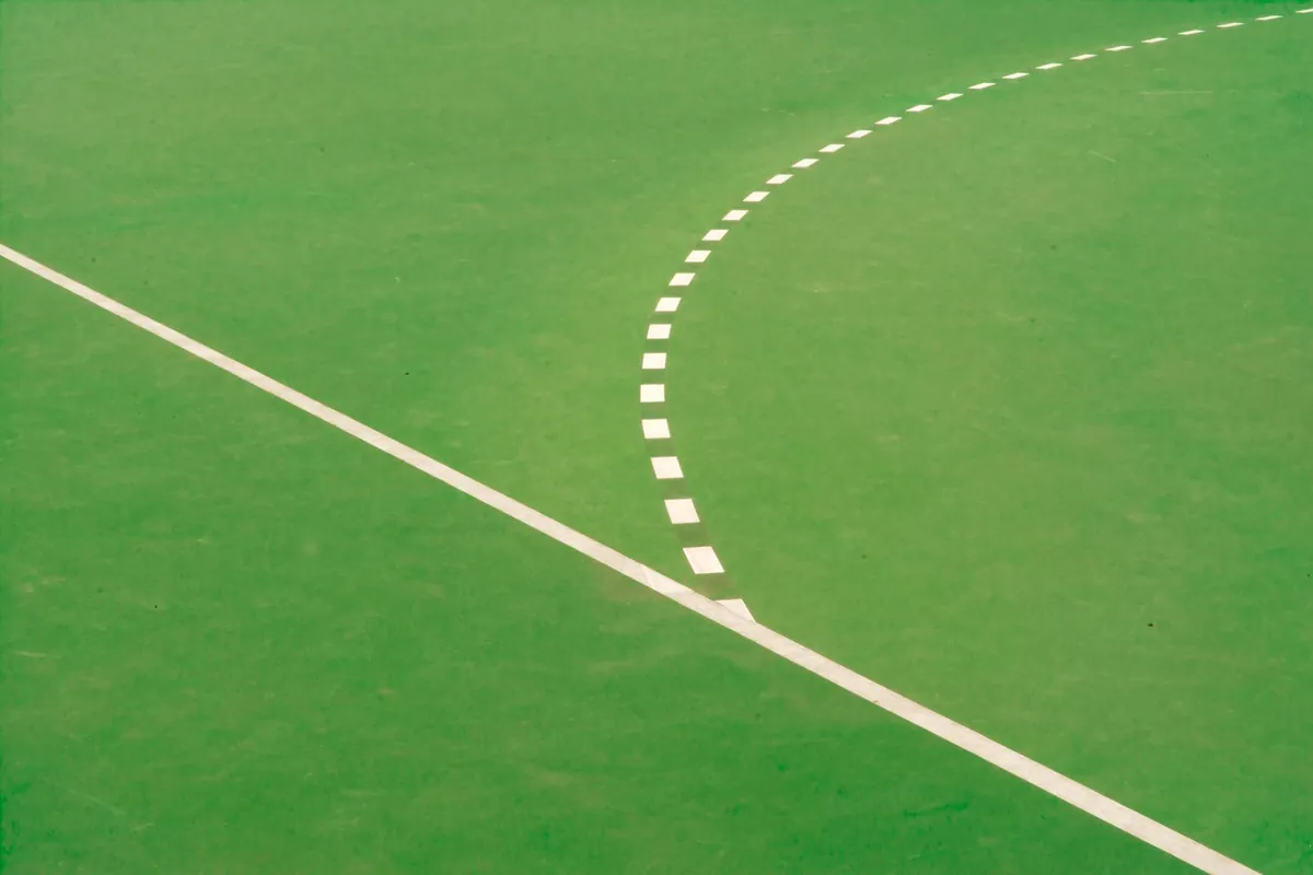 White line markings running across a green artificial turf field