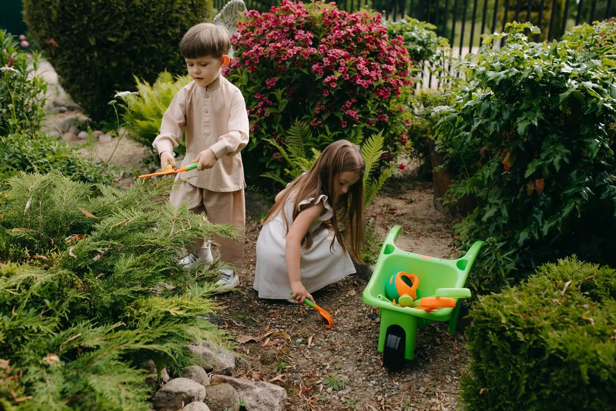 Children playing on a soft artificial grass play area with a shock pad underneath