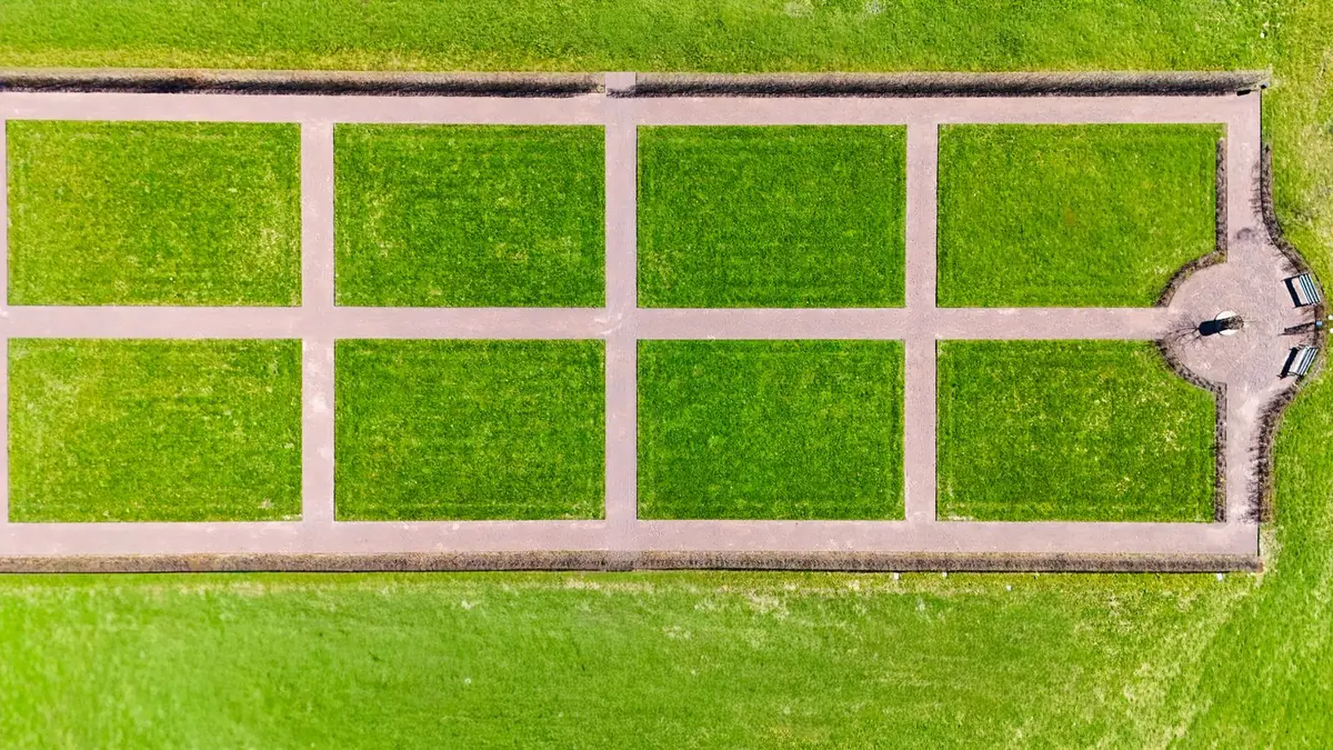 Completed backyard lawn laid in artificial grass beside a paved patio