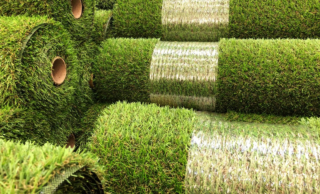 Warehouse of artificial grass rolls sealed in protective packaging