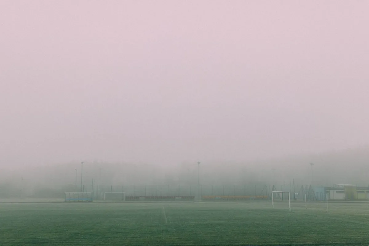 football pitch on a cold foggy winter morning