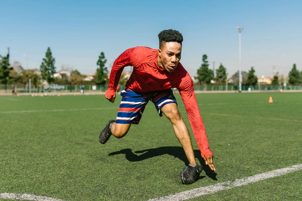 Man sprinting outdoors on a sunny day for speed training