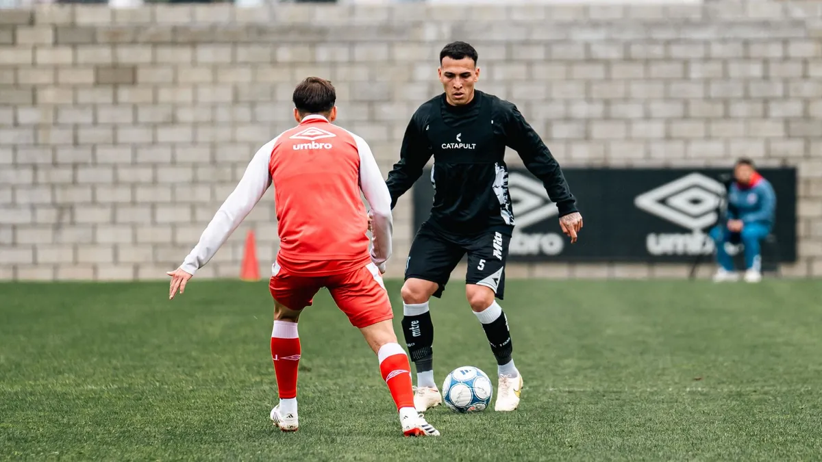 Soccer players in a dynamic training drill on artificial turf