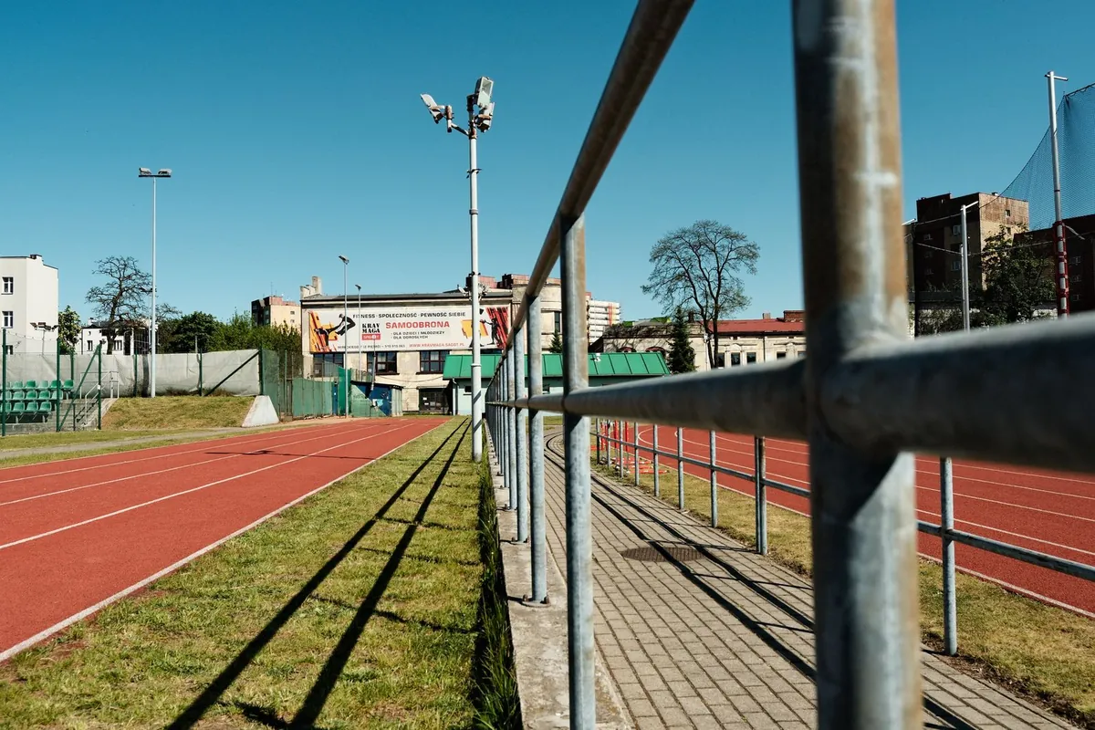 Outdoor running track and stadium under blue skies