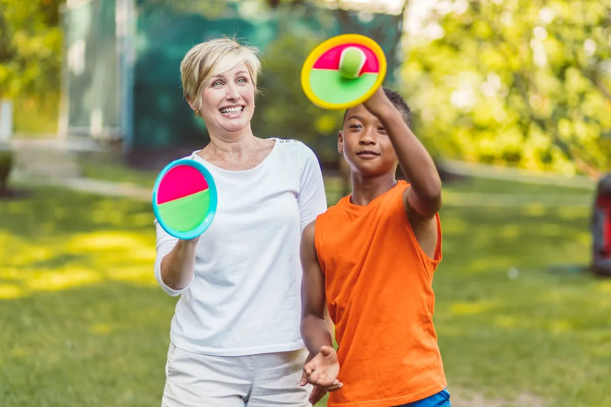 Family playing a ball game on a coloured court