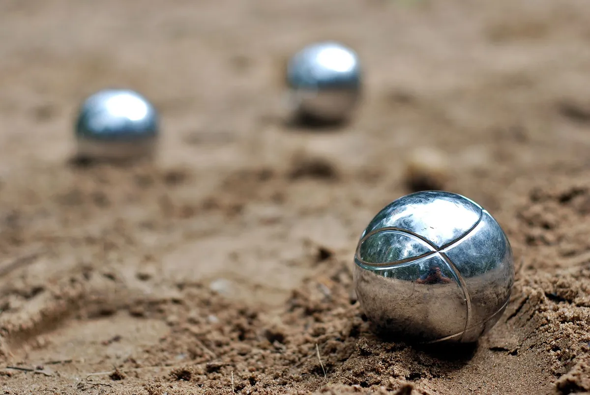 Bocce boules resting on the court surface
