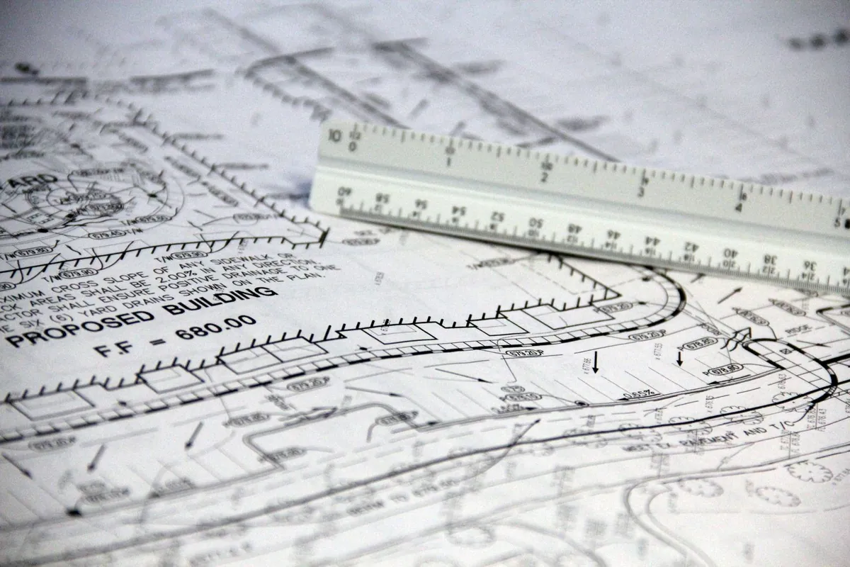 Architectural blueprints with scale ruler for project planning