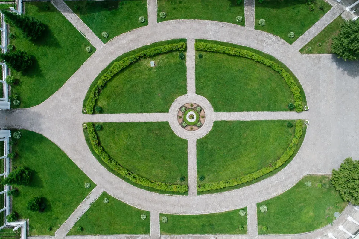 Aerial view of symmetrical pathways and lush green lawn
