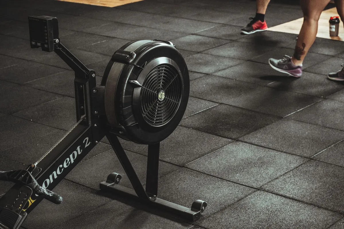 Commercial gym functional training zone with artificial turf under sled and weights