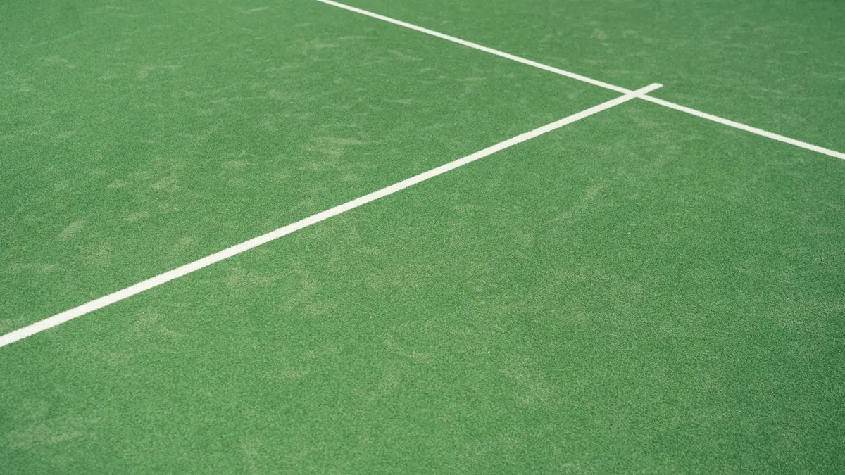 White pitch markings crossing a green playing surface