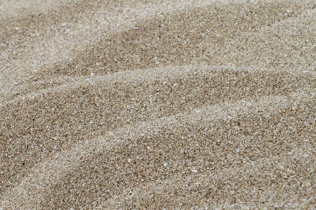 Fine grit and small stones raked into a levelled base course