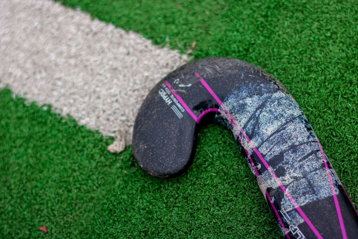 Water-based hockey pitch under high-tempo training with drag-flick and sweep action