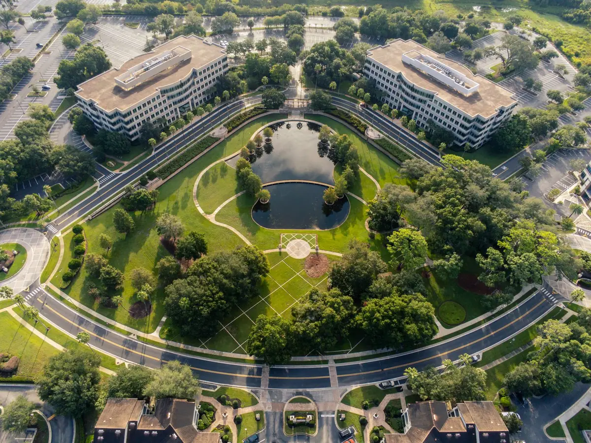 Office complex with landscaped green park and lawn seen from above