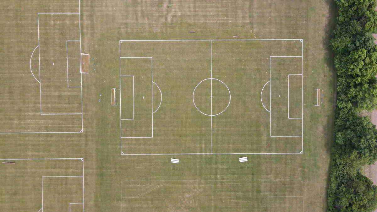 Green artificial grass field with white markings