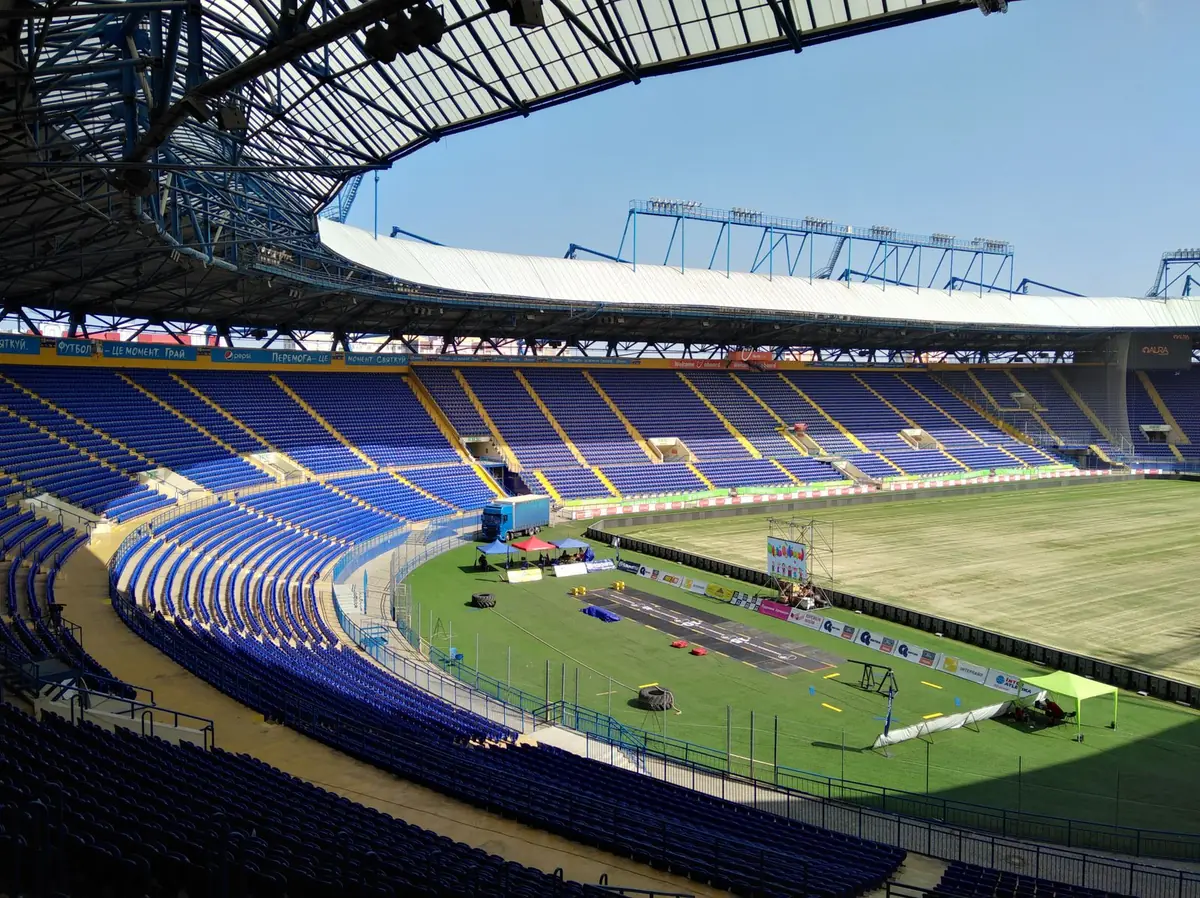 large domed stadium interior with sports pitch