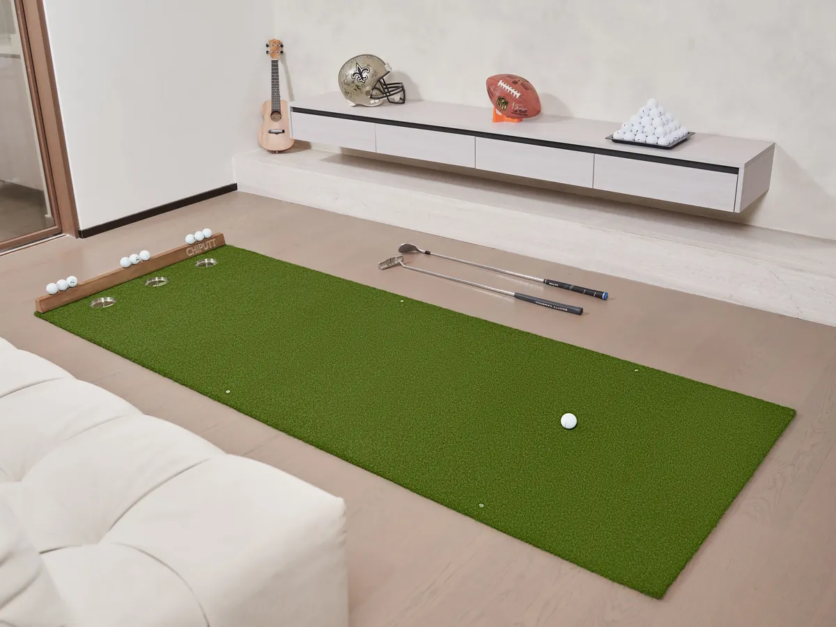 Cozy indoor setup with a green putting mat and clubs