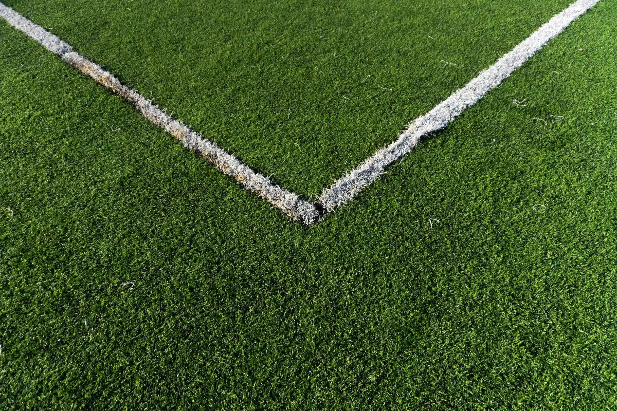 Finished artificial turf surface seam and pile texture in close-up