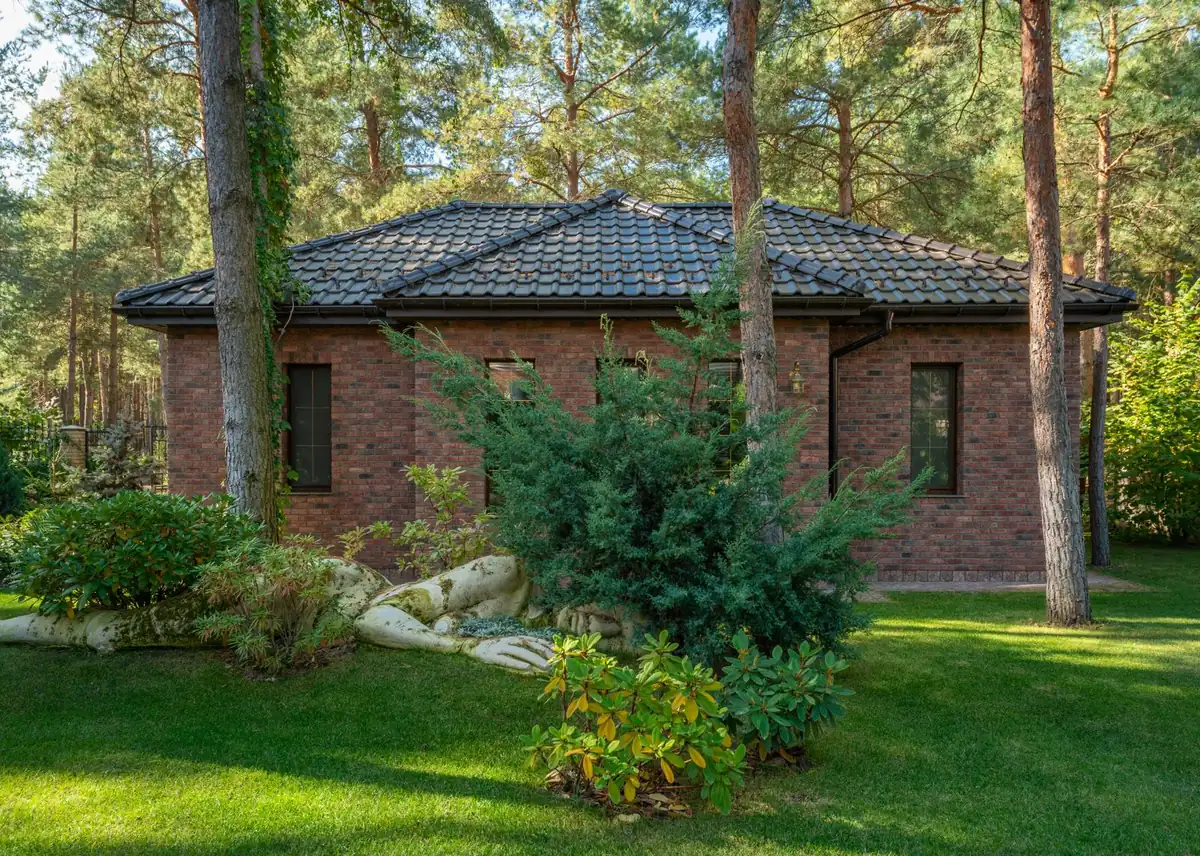 Residential landscape with mature artificial turf at end of several-year service life