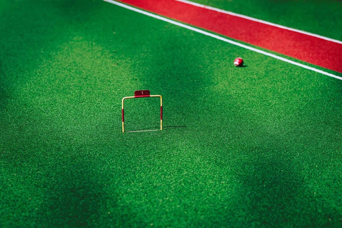 A ball resting on a smooth synthetic turf court