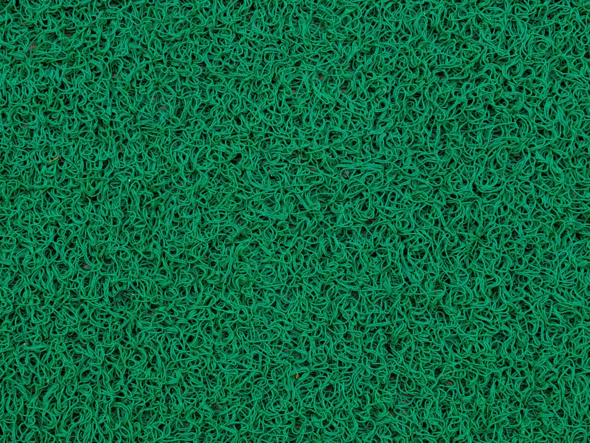 Detailed texture of green artificial grass fibers