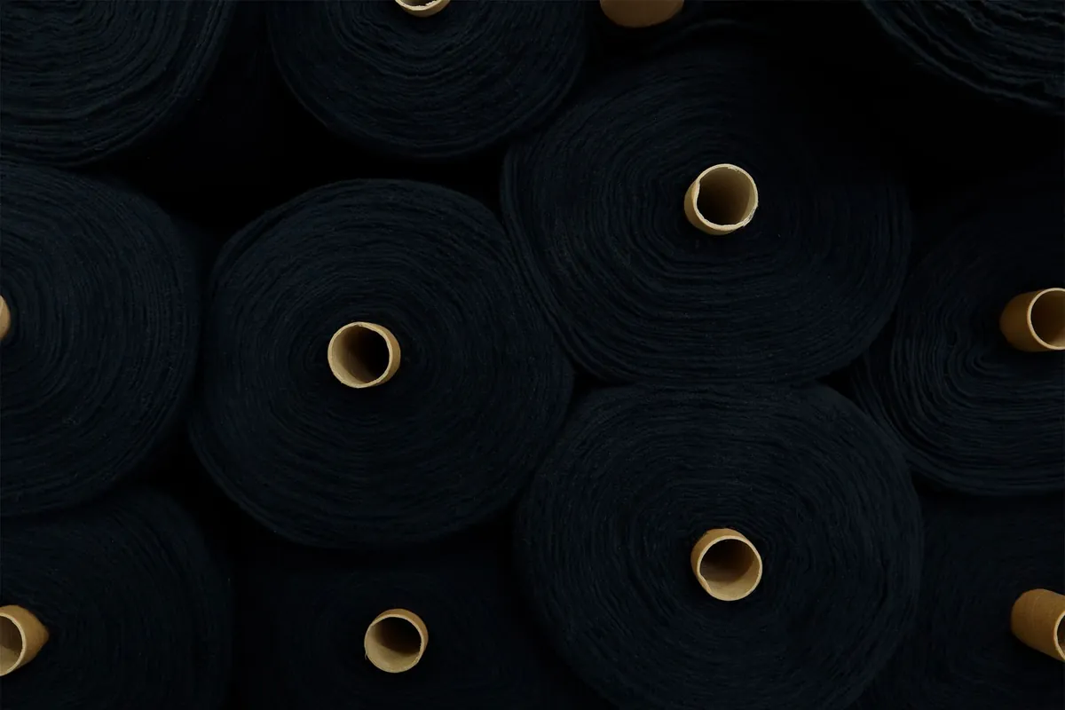 Material rolls stacked in an industrial setting