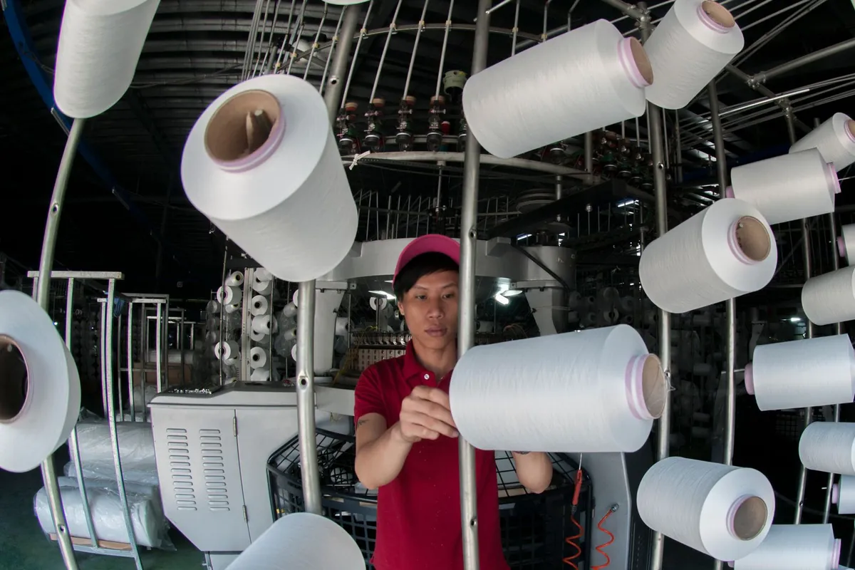 Yarn spools lined up on a textile production line