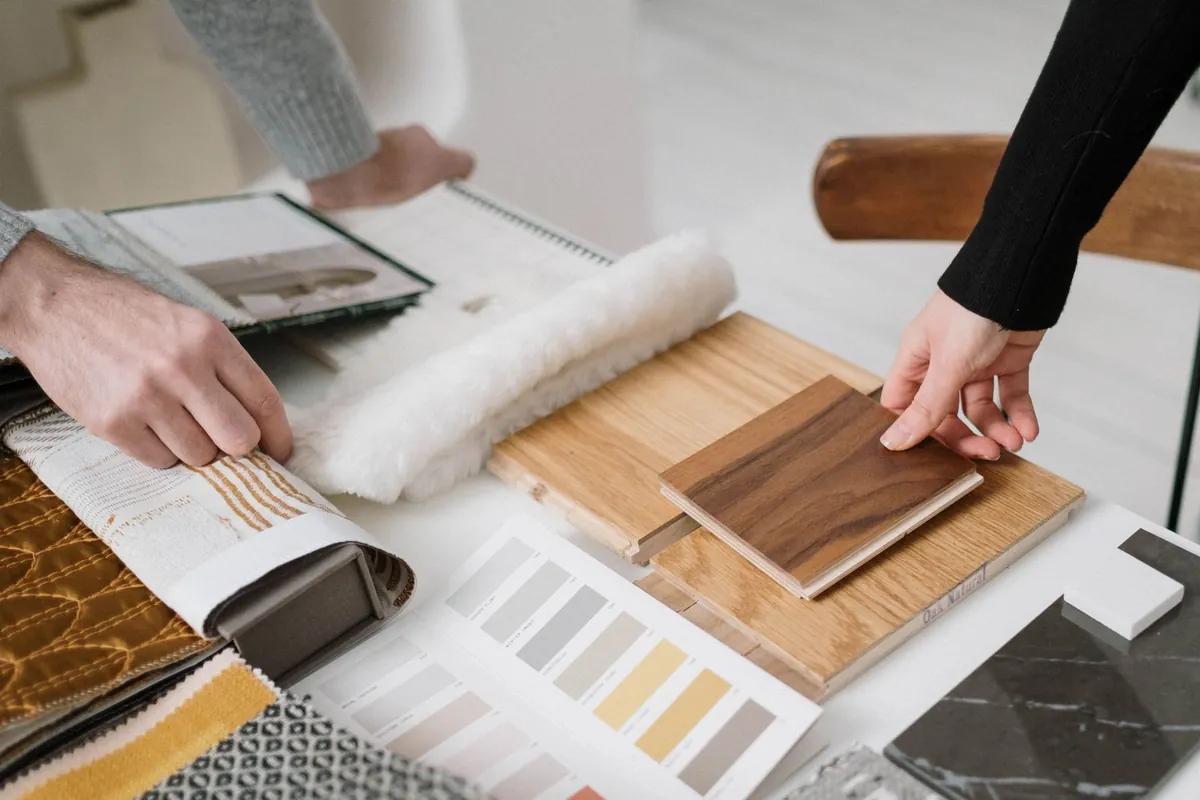 Hands selecting and comparing material samples