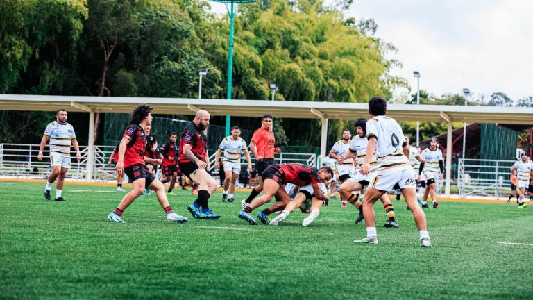 Intense rugby match with players tackling on the field.