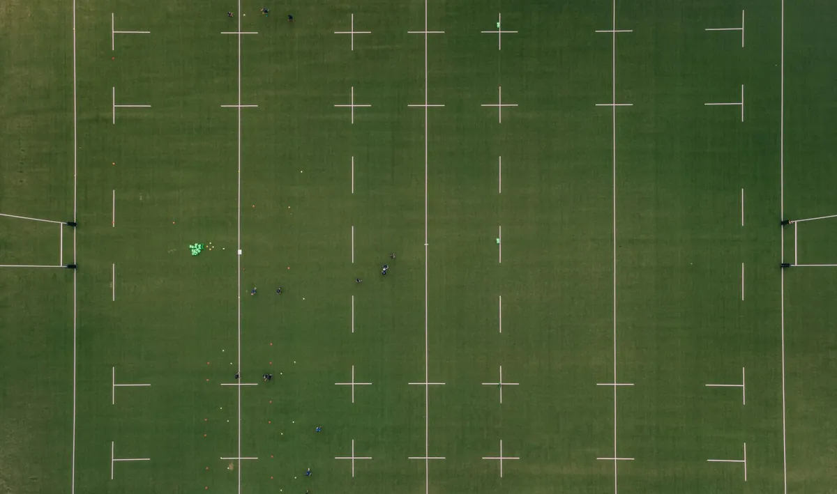 Empty rugby stadium pitch seen from the stands