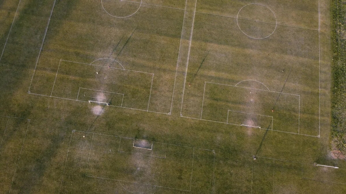 Aerial view of soccer fields with goalposts and green grass
