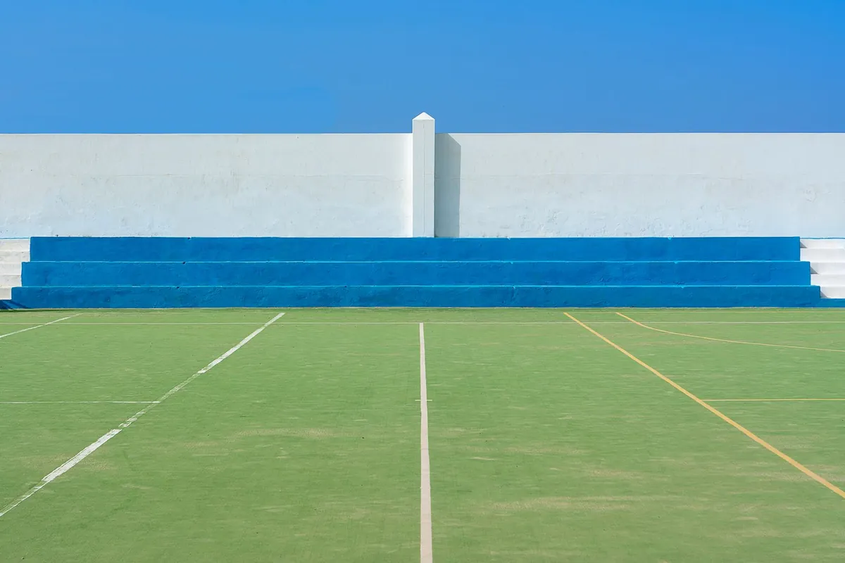 Green artificial grass pitch section in daylight