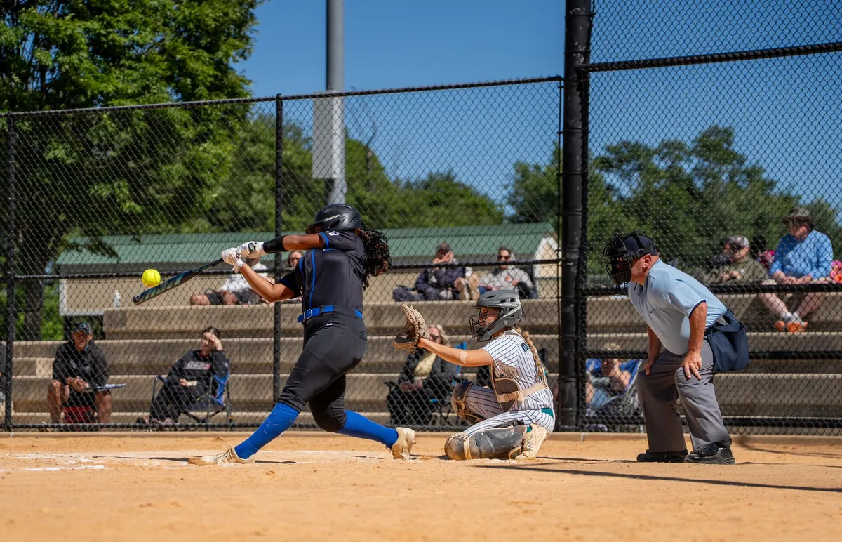 Softball players on a turf field during a game