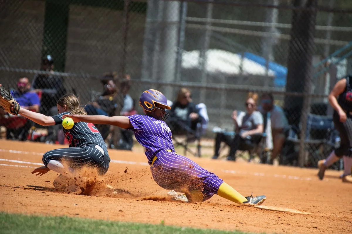 Softball game at the plate on a turf field