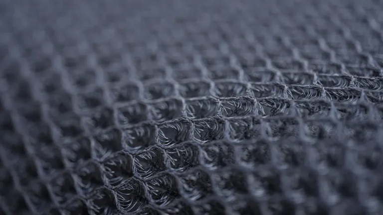Detailed macro shot of a textured synthetic fabric with intricate patterns.