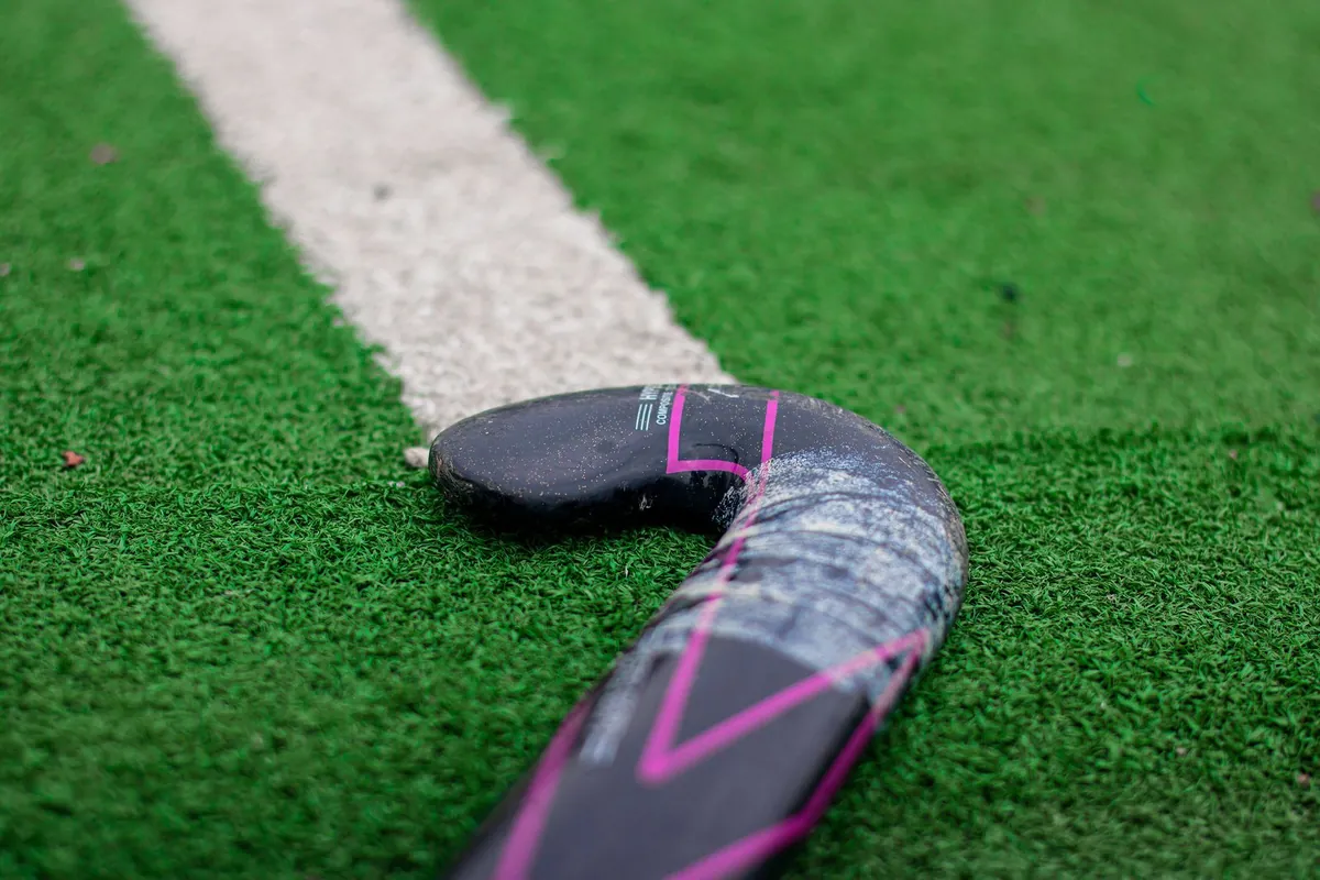 Closed-cell PE foam shock pad being laid over a compacted stone base under artificial turf