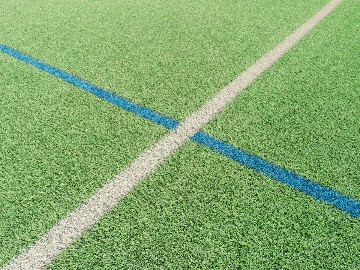 Close-up of artificial grass roll showing pile density and backing relevant to synthetic turf sports fields specification