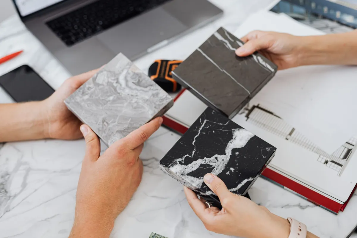 Designer comparing material samples on a desk for quality testing