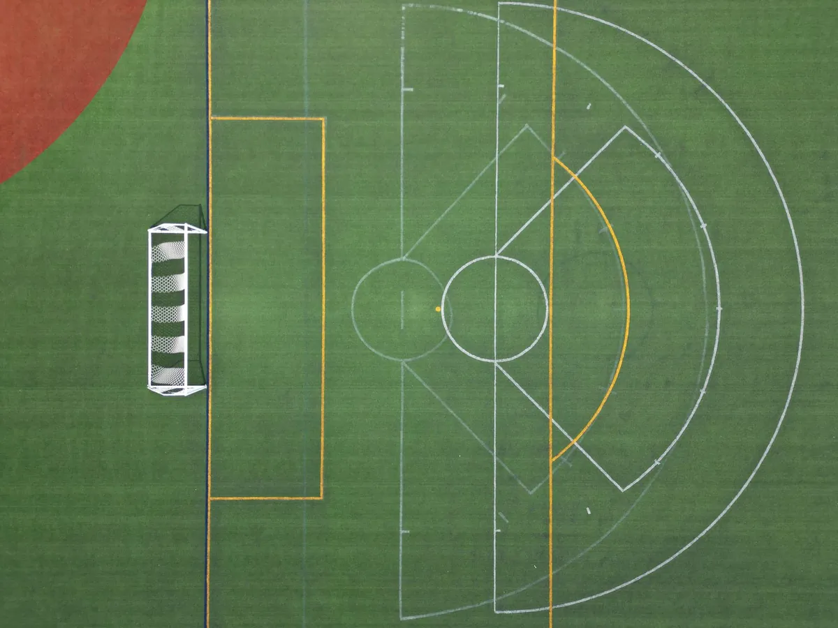 Green artificial turf field with white line markings